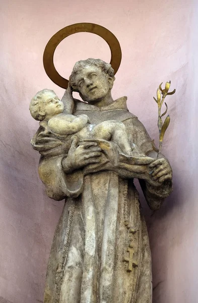 Saint Anthony of Padua holding baby Jesus, statue on the facade of the Saint Francis church in Budapest, Hungary