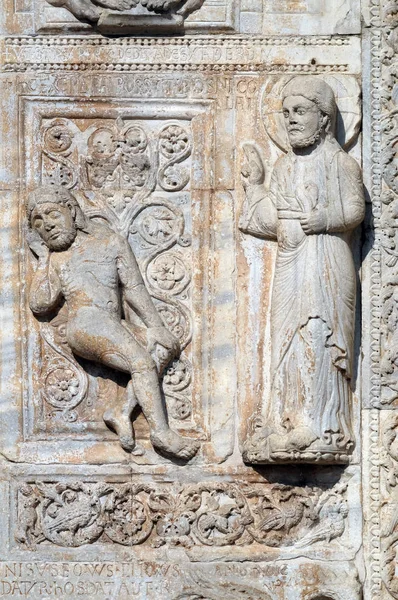Creation of Adam, medieval relief on the facade of Basilica of San Zeno in Verona, Italy