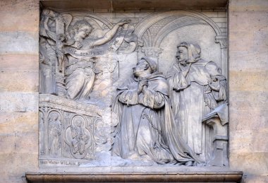 Relief on the portal of Saint Thomas Aquinas in Paris, France clipart