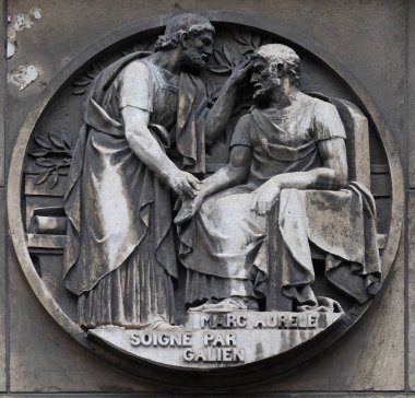 Marc Aurele heals by Galen. Stone relief at the building of the Faculte de Medicine Paris. clipart