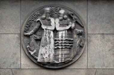 Marduk and Ea. Stone relief at the building of the Faculte de Medicine Paris, France clipart