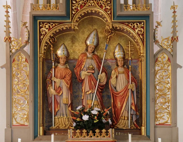 Saint Martin, Nicholas and Sylvester, statues on the main altar in the Saint Nicholas church in Petschied near Luson, Italy