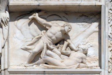 Cain killing Abel, marble relief on the facade of the Milan Cathedral, Duomo di Santa Maria Nascente, Milan, Lombardy, Italy clipart