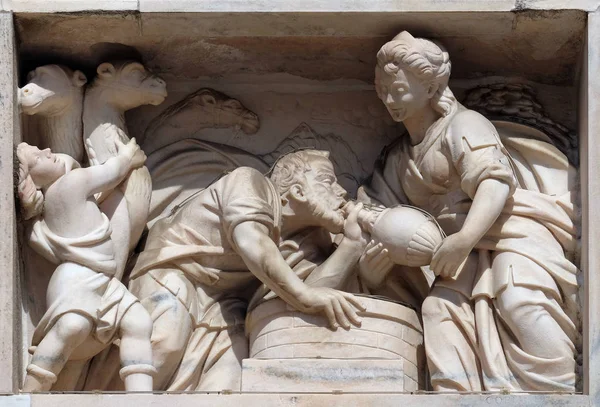 Rebecca at the well, marble relief on the facade of the Milan Cathedral, Duomo di Santa Maria Nascente, Milan, Lombardy, Italy