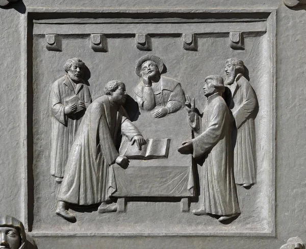 Luther and Zwingli dispute about the Lord\'s Supper at Marburg, relief on the door of the Grossmunster (\