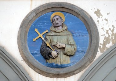 St. Francis of Assisi, glazed terracotta tondo by Andrea della Robbia, located between two arches of the old Ospedale di San Paolo, in Florence, Italy clipart