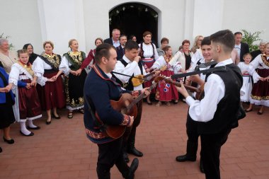 People sing and dance after the Mass on Thanksgiving day in Stitar, Croatia clipart