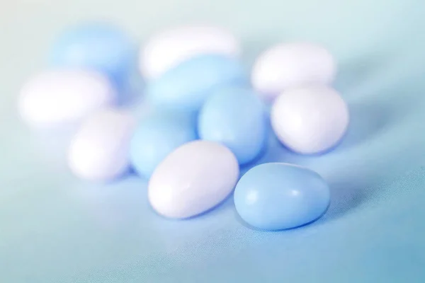 Çeşitli fullcolor mavi ve beyaz şeker mavi arka plan üzerinde dragees.