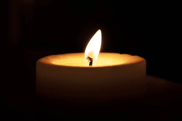 Candle burns on a window sill — Stock Photo, Image