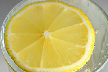 Yuvarlak limon dilimi, gevşek soda, ferahlatıcı limonata, yakın plan makro fotoğraf, vejetaryen arka plan.