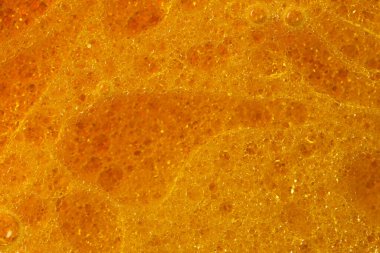 Petrol ve yağ çözücüden su kabarcıkları içeren soyut kırmızı ve sarı arkaplan makro fotoğrafçılığı kapat