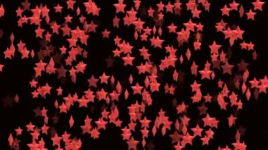 Siyah arkaplan üzerinde kırmızı hacimli dönen yıldızların soyut canlandırılmış video arkaplan bilgisayarı