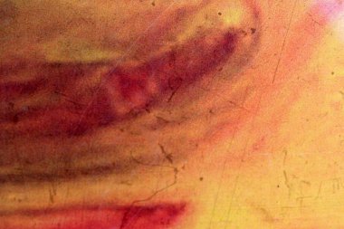 Kırmızı ve sarı kıvrımlı kalın renkler büyüleyici bir sanatsal kompozisyon oluşturuyor..