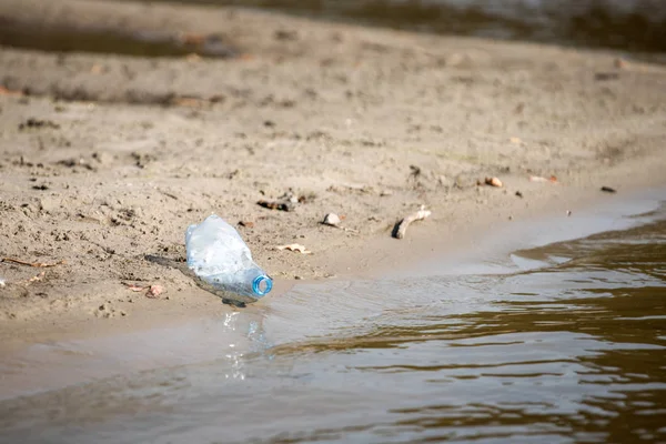 plaj kum üzerinde parçalanmış pet tek kullanımlık plastik şişe. Plastik kirliliği
