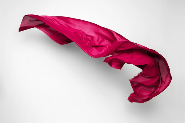 abstract piece of red fabric flying, high-speed studio shot