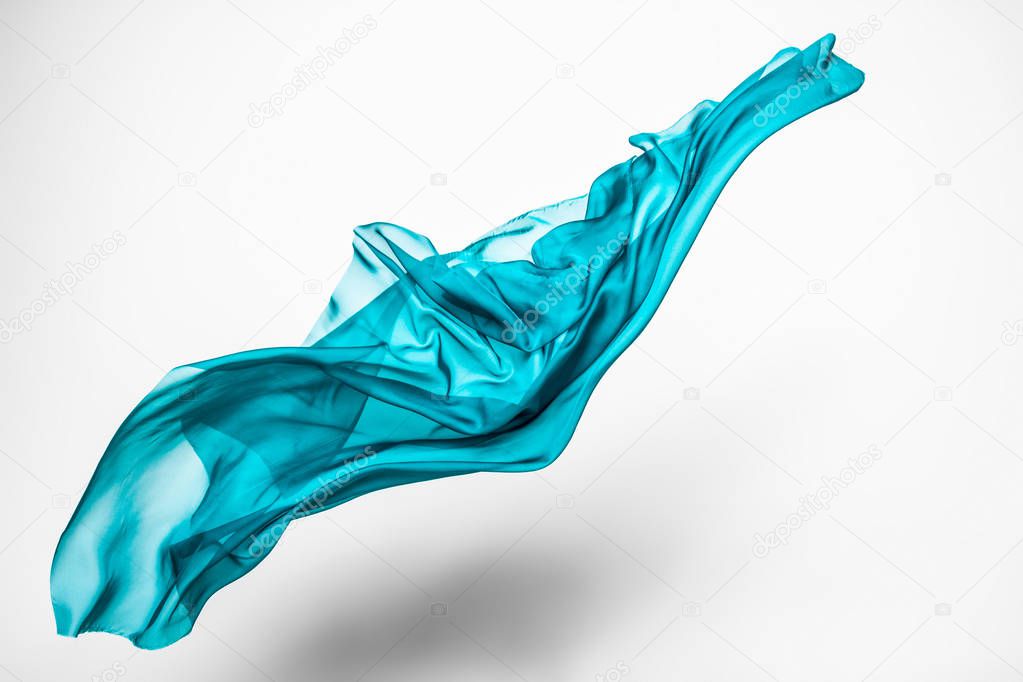 abstract piece of teal fabric flying, high-speed studio shot