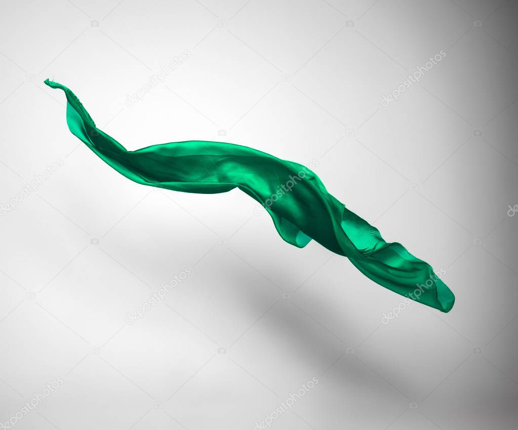 abstract piece of green fabric flying, high-speed studio shot