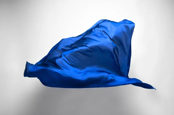 abstract piece of blue fabric flying, high-speed studio shot