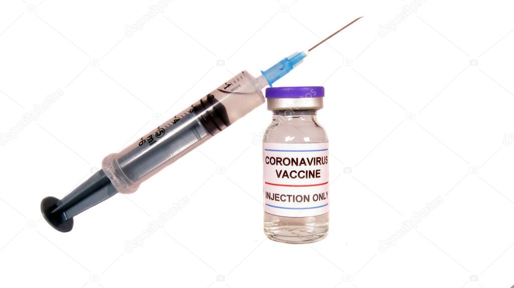 A vial bottle of coronavirus vaccine along with injection syringe, on white studio background.                               