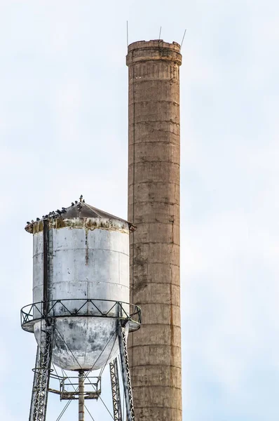 Smakestack e torre dell'acqua per zuccherificio abbandonato — Foto Stock