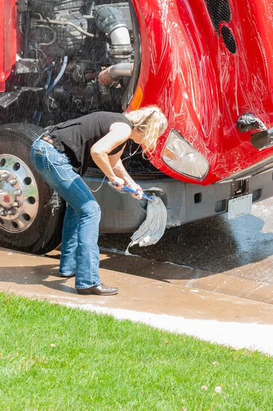 Vrouw vrachtwagenchauffeur wassen semi-truck thuis — Stockfoto