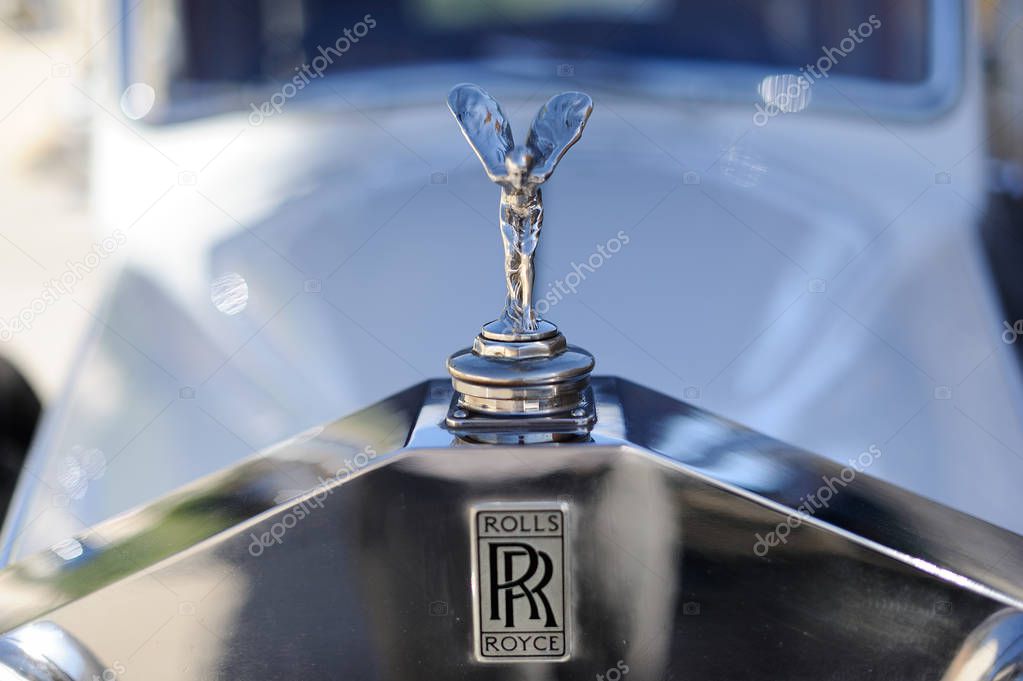 Close up detail of Rolls Royce logo and figurine on car front
