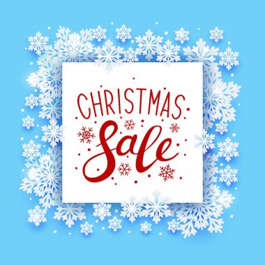 Mavi arka plan üzerinde kağıt kar taneleri çerçeve ile Noel tebrik kartı