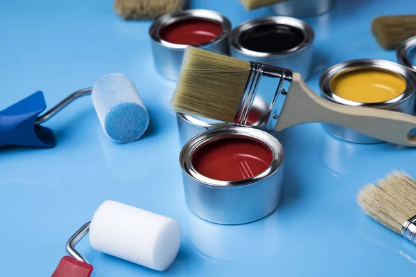 Metal tin cans with color paint and paintbrush