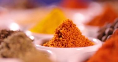 Mutfak masasında çeşitli baharatlar ve otlar var.