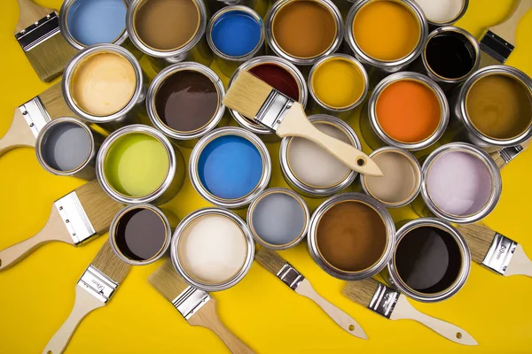 Metal tin cans with color paint and paintbrush