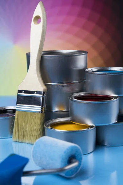 Tin cans with paint, brushes and bright palette of colors