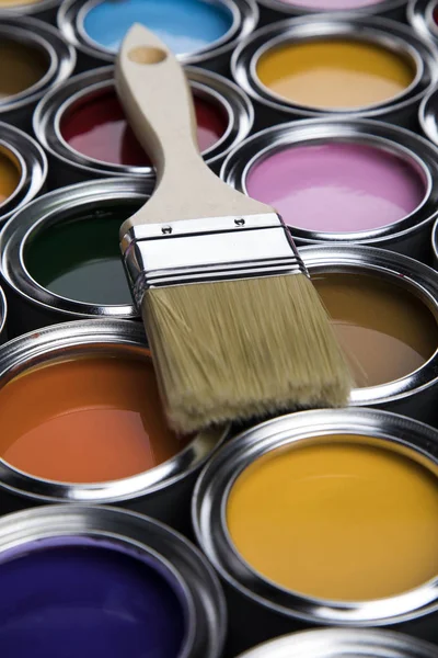 Tin cans with paint, brushes and bright palette of colors