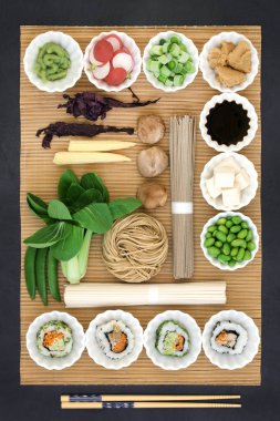 Sağlıklı makrobiyotik Japon gıda udon ve soba erişte, Suşi, tofu, wasabi ve miso yapıştırın, sebze ve soya gıdalar yüksek protein, antioksidanlar, mineraller ve vitaminler bambu ve arduvaz arka plan, üstten görünüm ile.