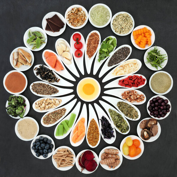 Health food to boost brain power in porcelain dishes on slate background. Super food concept  high in omega 3 fatty acids, antioxidants, vitamins, minerals and anthocyanins. Top View 