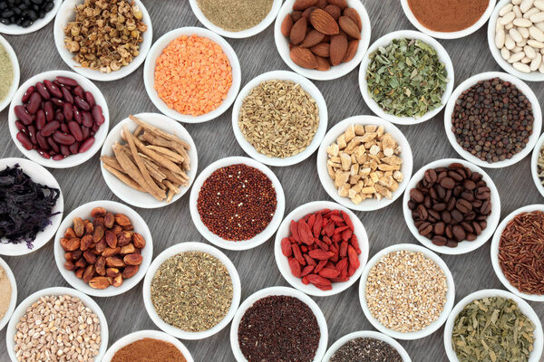 Dried diet health food with grains, cereals, legumes, nutritional supplement powders, fruit, seeds, nuts and herbs used as appetite suppressants. Foods high in omega 3, antioxidants, fibre and vitamins. Top view.