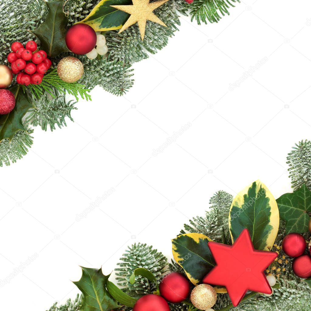 Christmas background border with red and gold star and ball bauble decorations, holly, fir, mistletoe and ivy isolated on white background.  Festive theme.