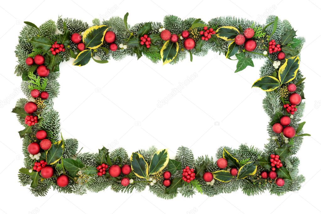 Christmas decorative background border with red bauble decorations, holly, fir, mistletoe and ivy isolated on white background. Festive theme.