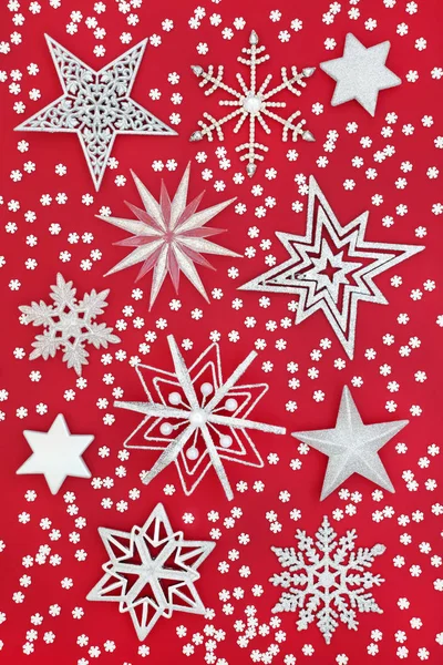 Christmas star and snowflake bauble decorations on red background. Traditional Christmas greeting card for the holiday season.