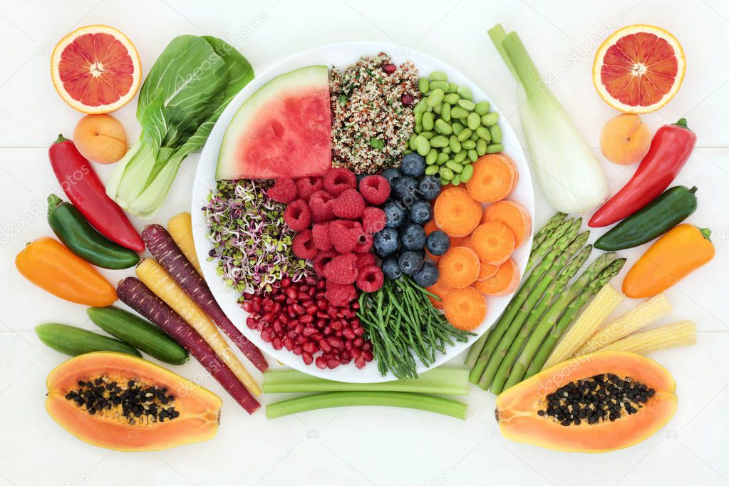 Health food for fitness  concept with fresh fruit, vegetables and grain salad with super foods very high in antioxidants, protein, anthocyanins, vitamins and dietary fibre. Top view on white wood.