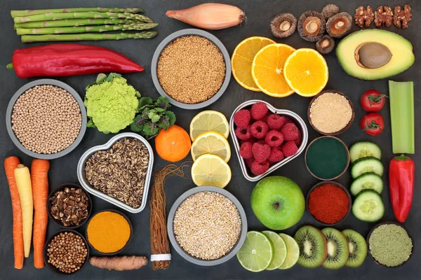Liver detox diet health food concept with fruit, vegetables, herbal medicine, seeds, nuts, grains, cereals, and supplement powders. High in antioxidants, omega 3, vitamins &  dietary fibre. Top view.