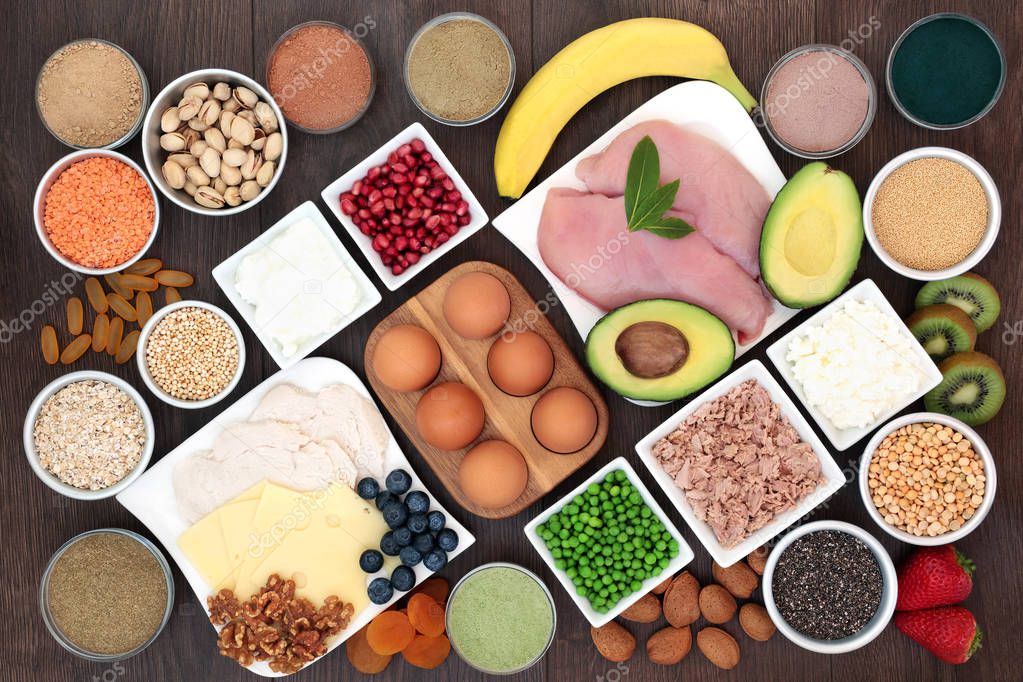 Health food for body builders with high protein lean meat, dairy, dietary supplement powders, pulses, seeds, nuts, grains, cereals, fruit and vegetables.