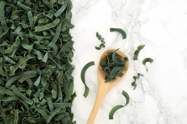 Sprouted Spelt Spirulina Organic Tagliatelle Pasta Wooden Spoon Loose Marble — Stock Photo, Image