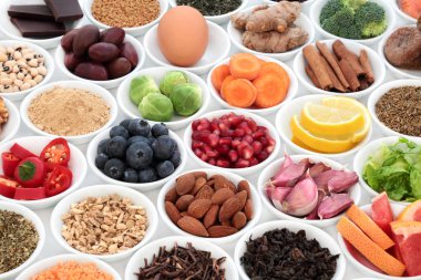 Super food to slow the ageing process concept including fruit, vegetables, seeds, nuts, herbs, spices, green and black teas. Very high in antioxidants, anthocyanins, dietary fibre and vitamins. clipart