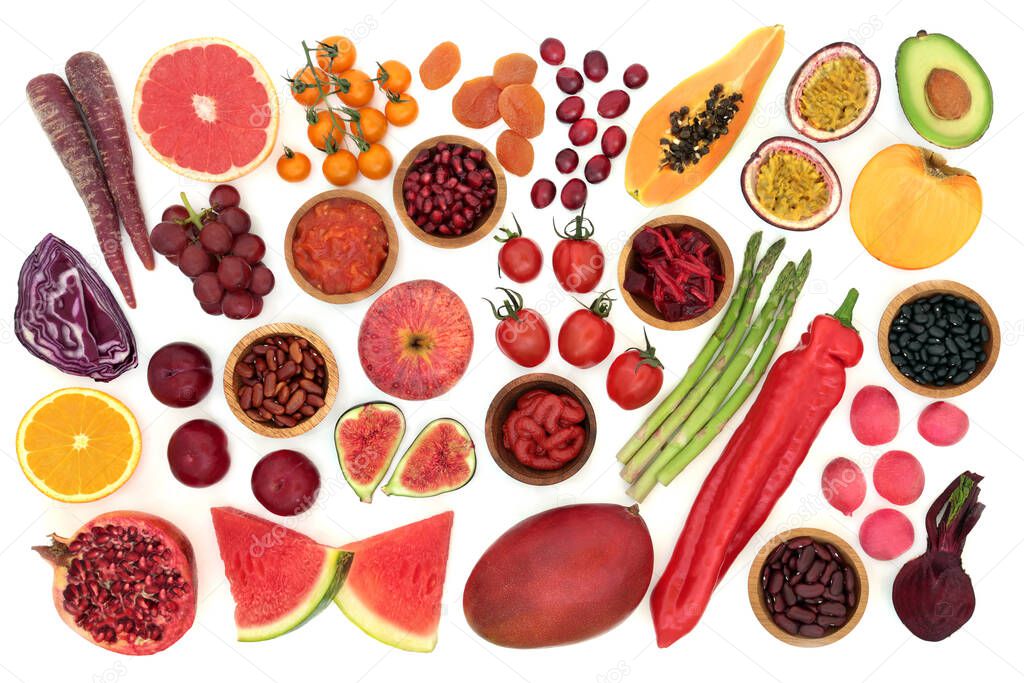 Immune boosting health food high in lycopene with a collection of fruit & vegetables. Foods also very high in antioxidants, dietary fibre, anthocyanins, minerals & vitamins. Flat lay, top view.