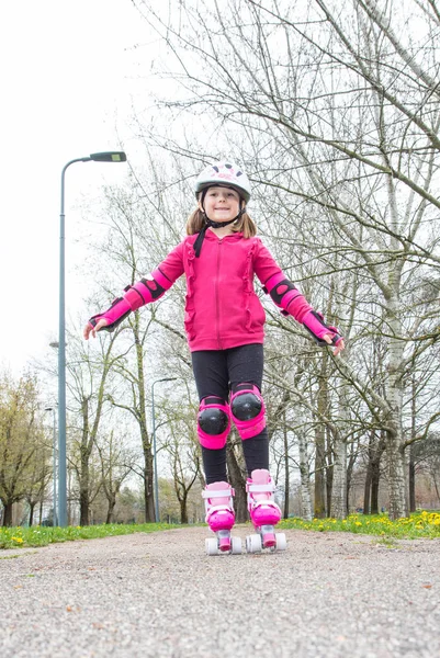 young girl with roller skates in the park