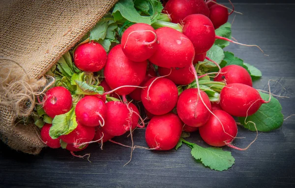 Fresh radish in a burlap sack — Stock Photo, Image