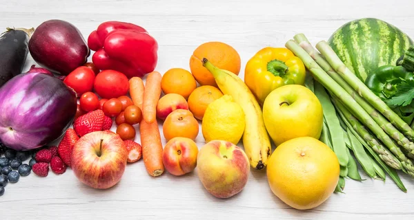 rainbow fruit and vegetables on wood