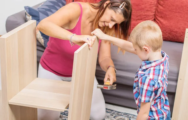 Mother and son are building the furniture — Stock Photo, Image