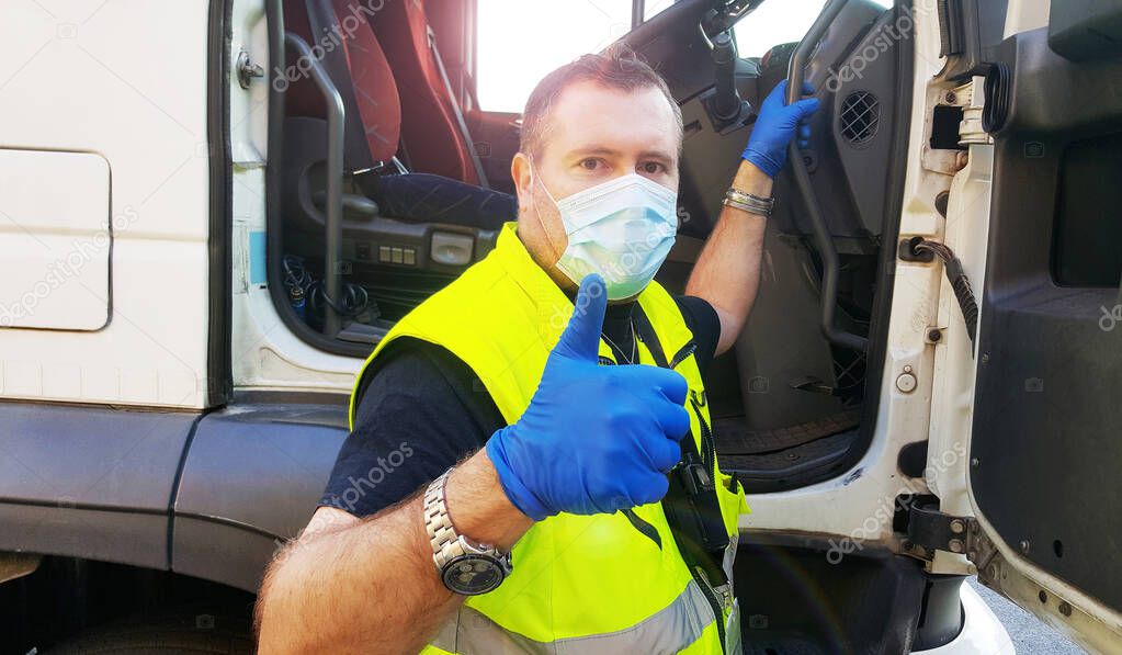 young transporter on the truck with face mask and protective gloves for Coronavirus