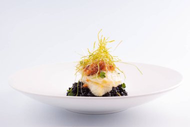 Tatlı biber sosu ve siyah risotto ile Şili levrek ızgara.